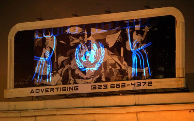 Réplica de Guernica con el logotipo de la ONU proyectado en la intersección de Hollywood and Sunset Boulevard
