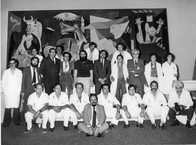 The technical team in charge of installing <em>Guernica</em> poses next to the work 