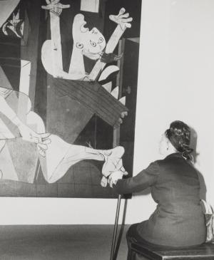 A visitor contemplating Guernica during the exhibition Pablo Picasso: A Retrospective