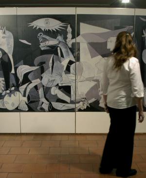EN Una mujer contempla uno de los paneles ilustrativos de la exposición «Pablo Picasso, Guernica. Historia de un cuadro»