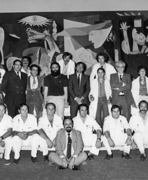 The technical team in charge of installing <em>Guernica</em> poses next to the work 